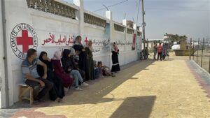 hospital with due of people outside in what looks like a desert setting
